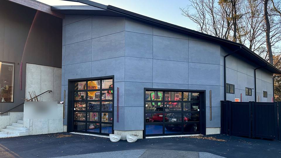 Commercial building with two full view glass garage doors