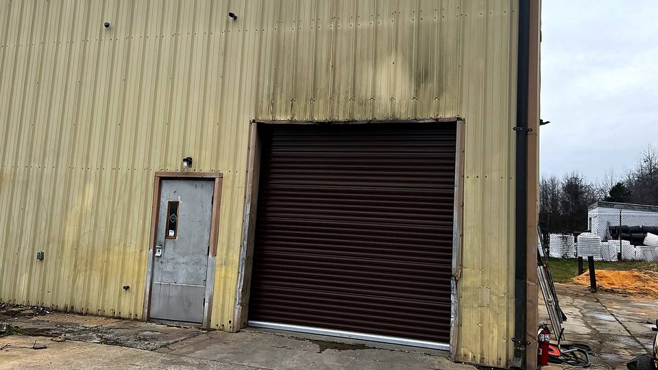 Brown commercial roll up door on a metal building