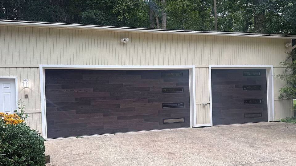 Dark wood look modern garage doors with window inserts
