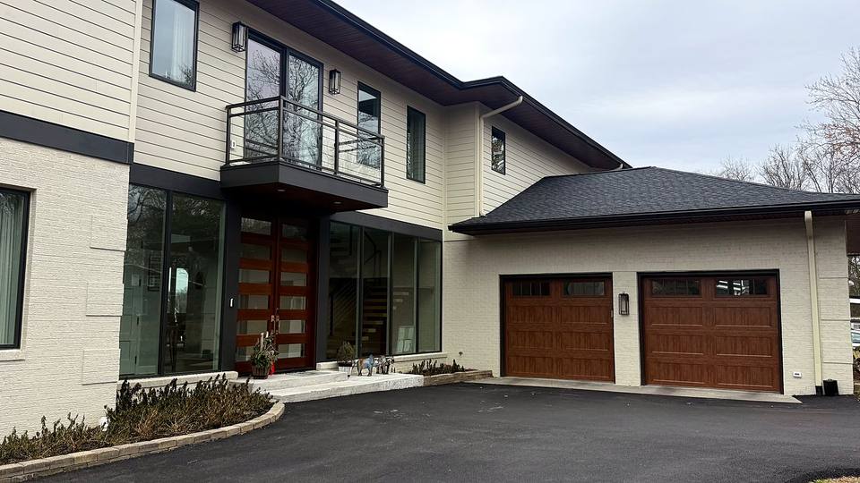 Modern home with two wood look carriage style garage doors
