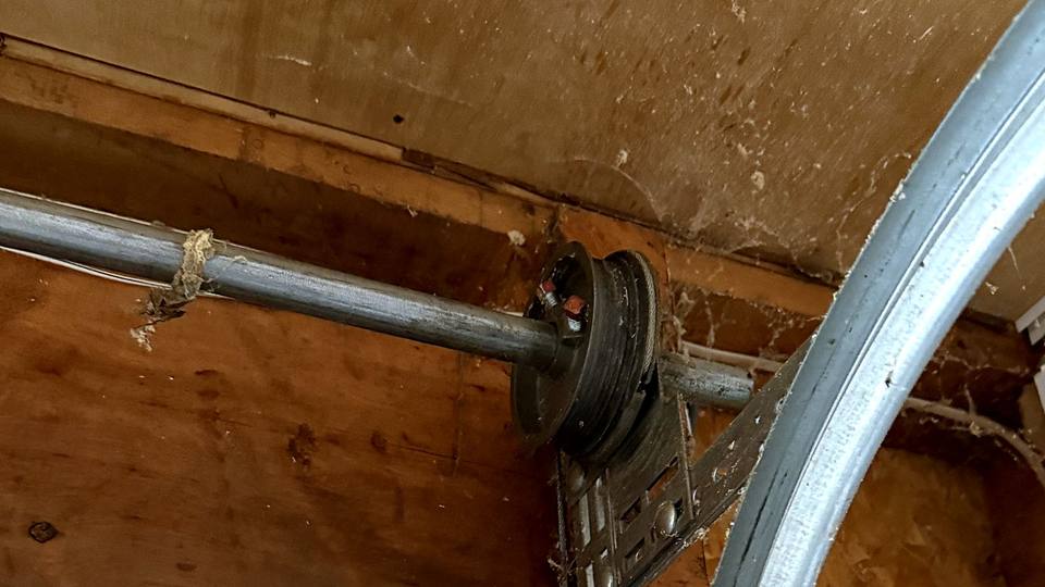 Torsion spring shaft, cable drum and track on a residential garage door