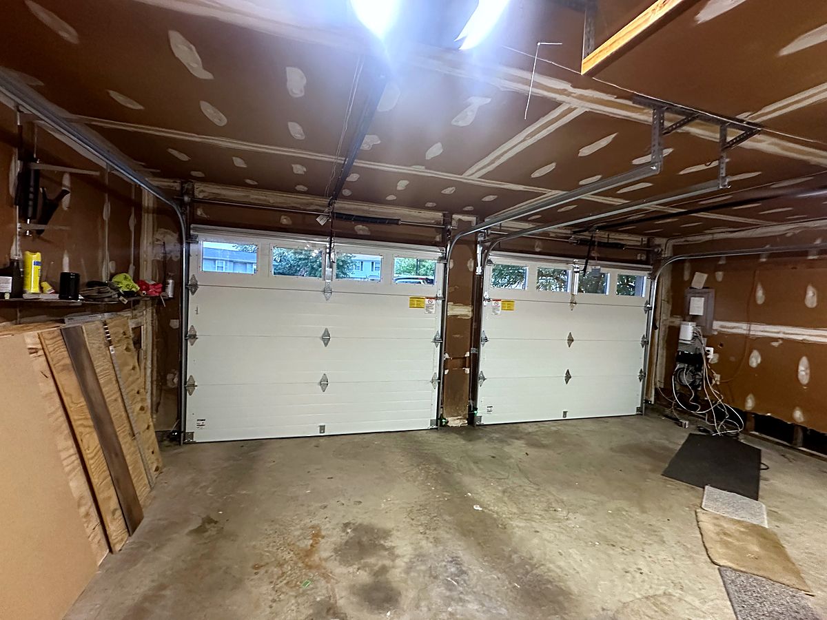 Inside a Hanover garage: two white insulated doors with window tops