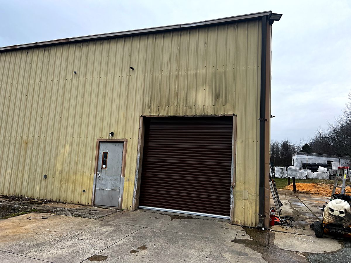 Brown commercial roll up door on a metal building in Havre de Grace