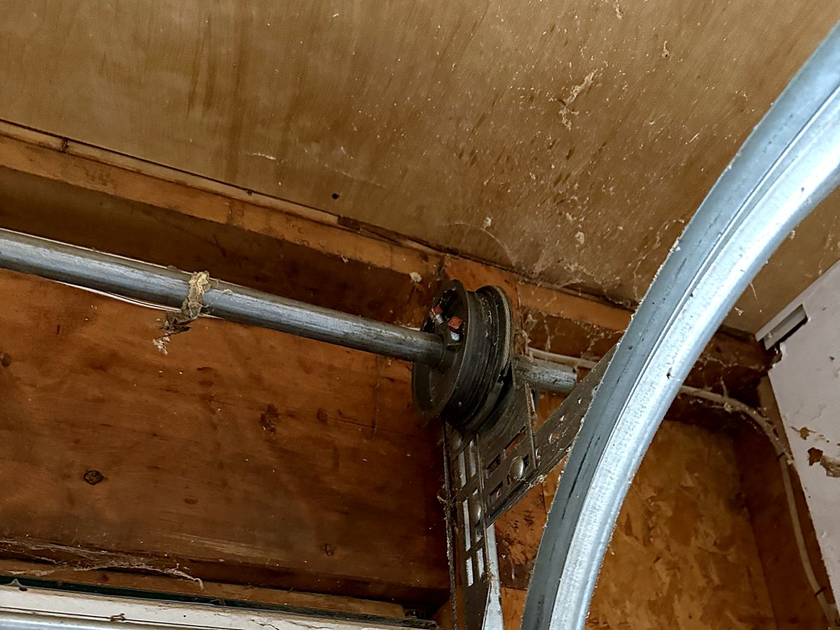 Spring shaft, cable drum and track hardware on a Manchester garage door