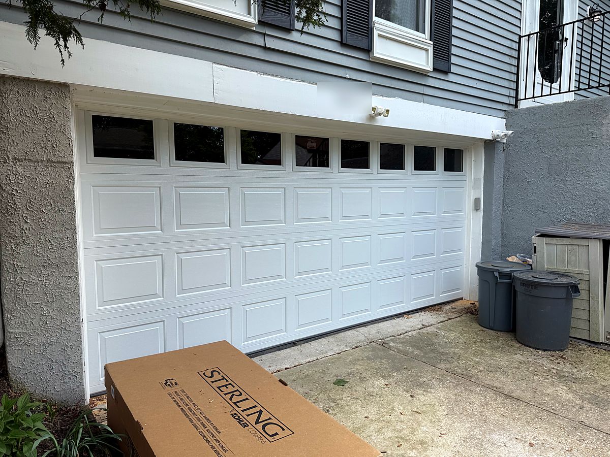 White two car garage door with a row of windows in Nottingham