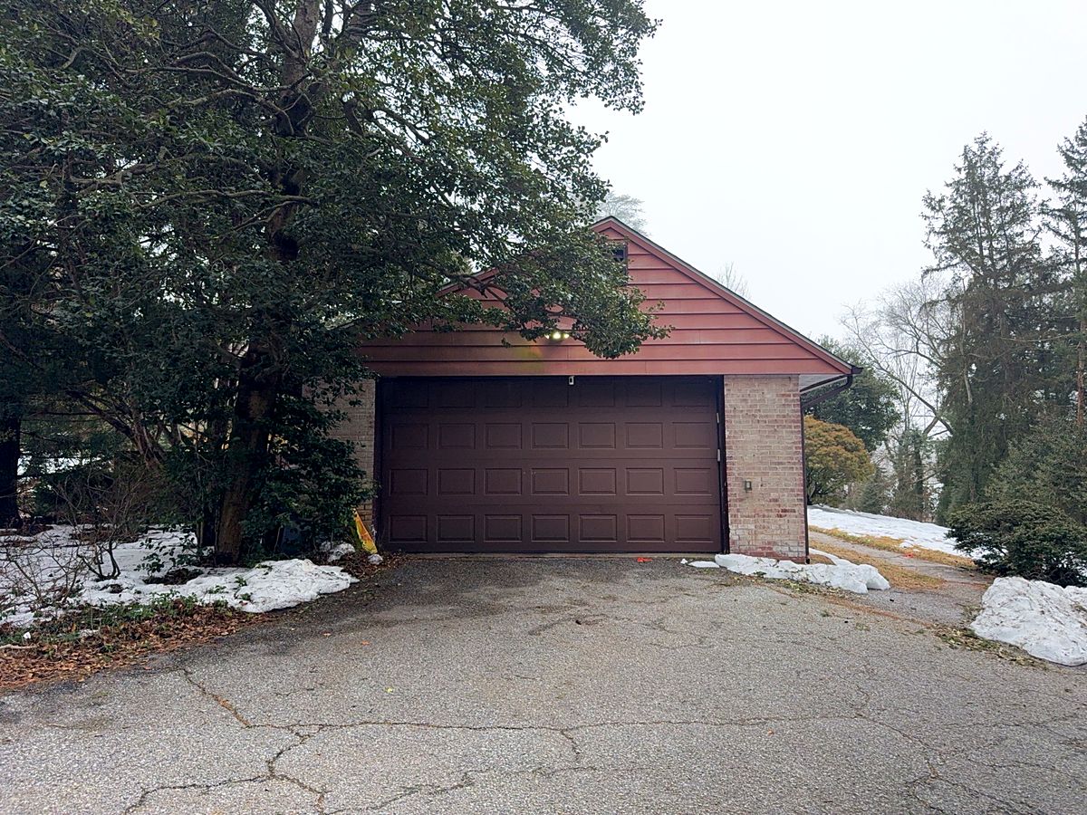 Brown raised panel two car garage door in Pikesville